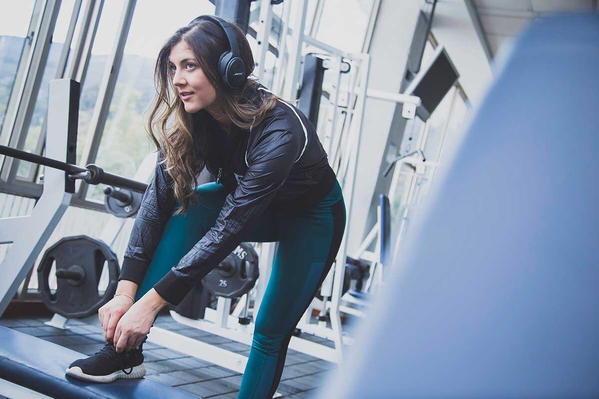 girl with headphones in the gym