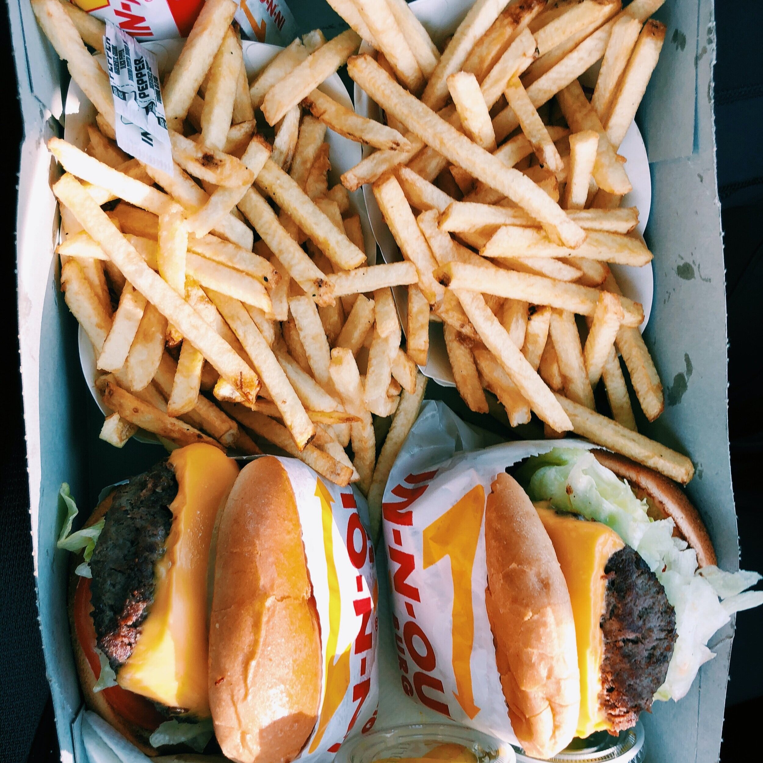 two burgers with fries